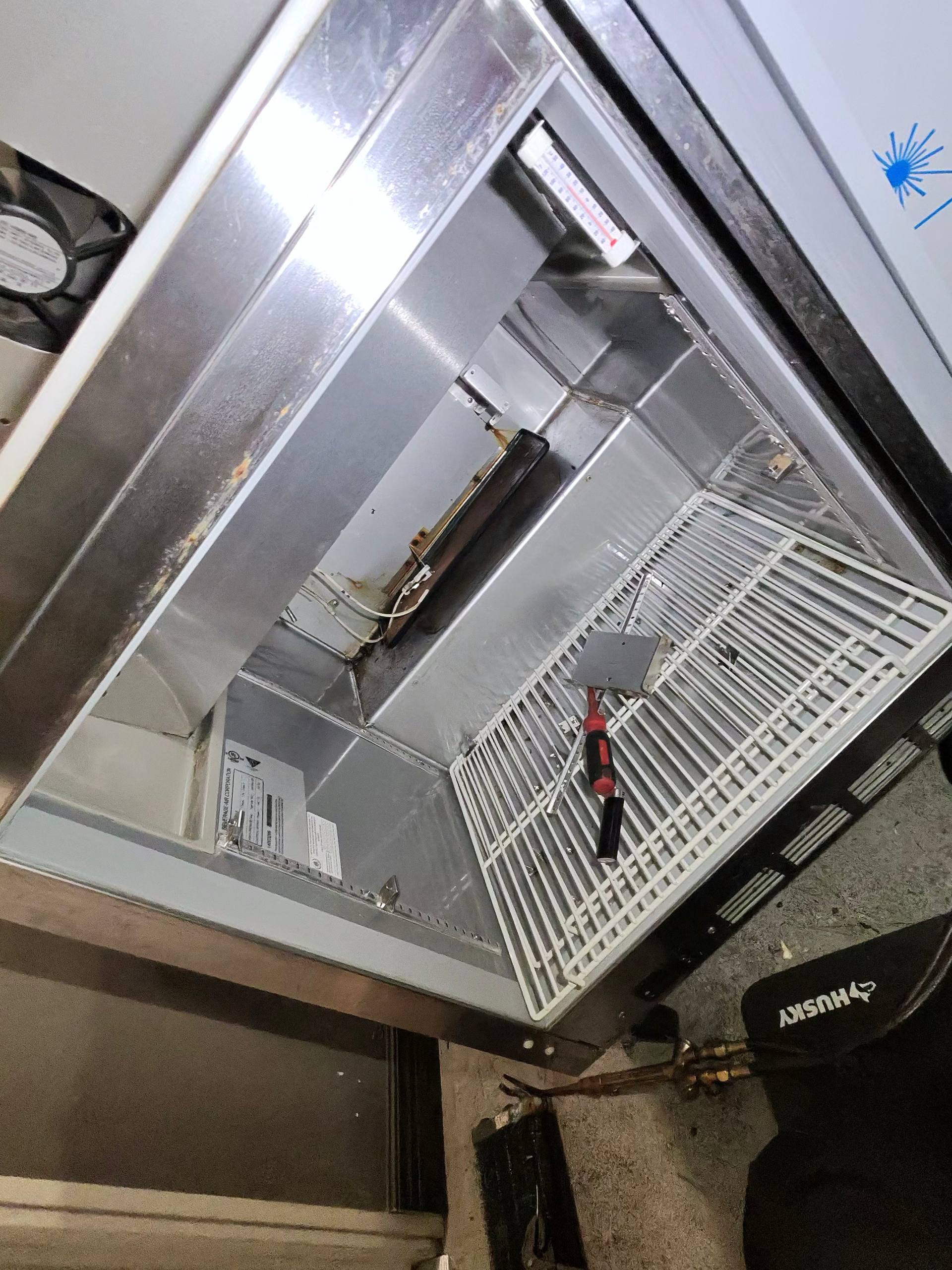 Interior view of the commercial cooler showing the old evaporator removed.